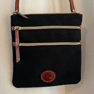 Dooney and Burke. Crossbody bag. Black with brown leather straps.